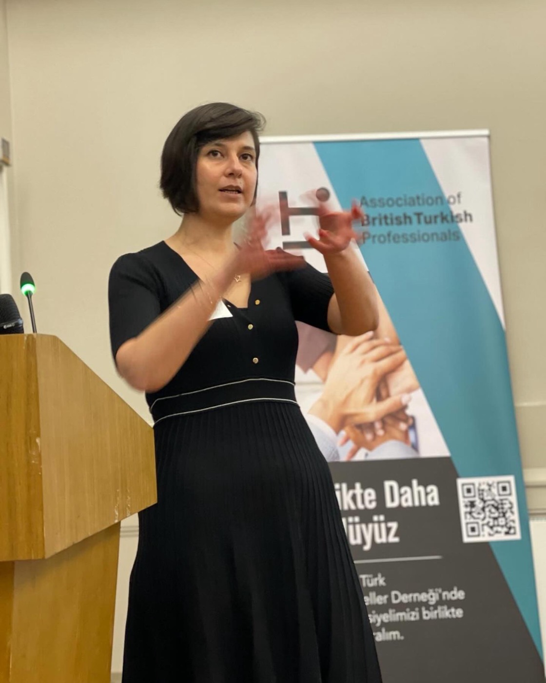 Oya Geron speaking at an event in London